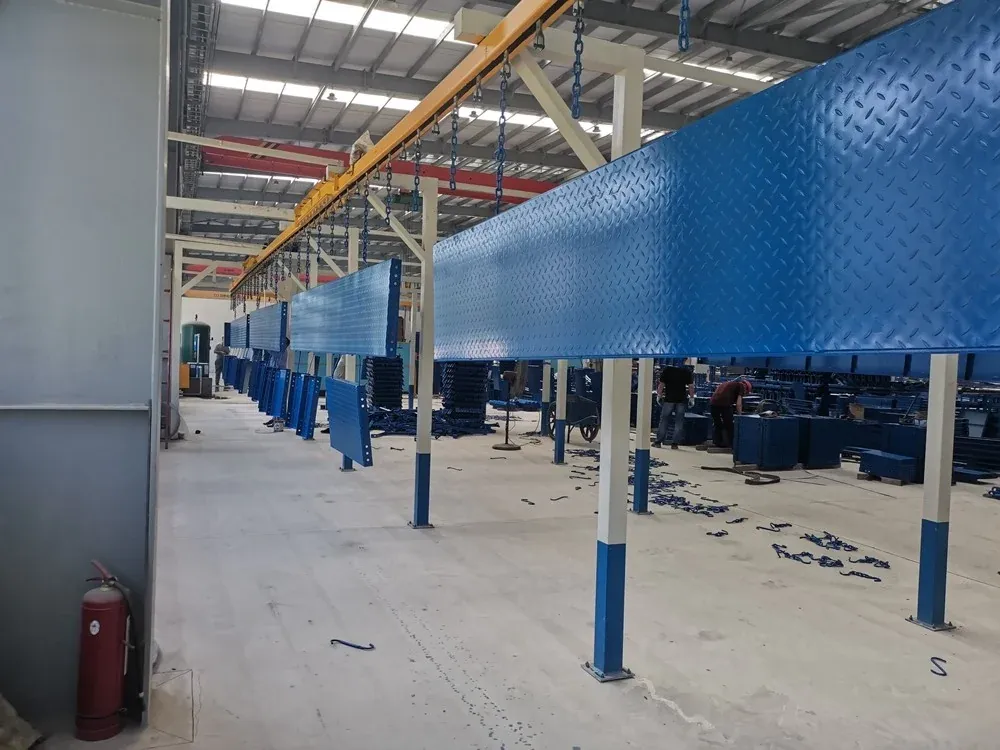 Climbing-frame mesh moving through a powder coating booth